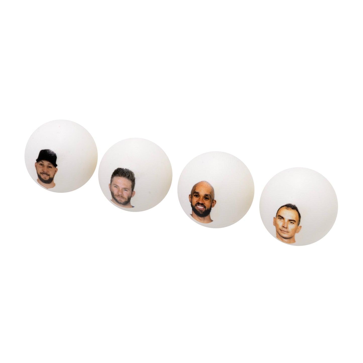 Four white ping pong balls with head shots