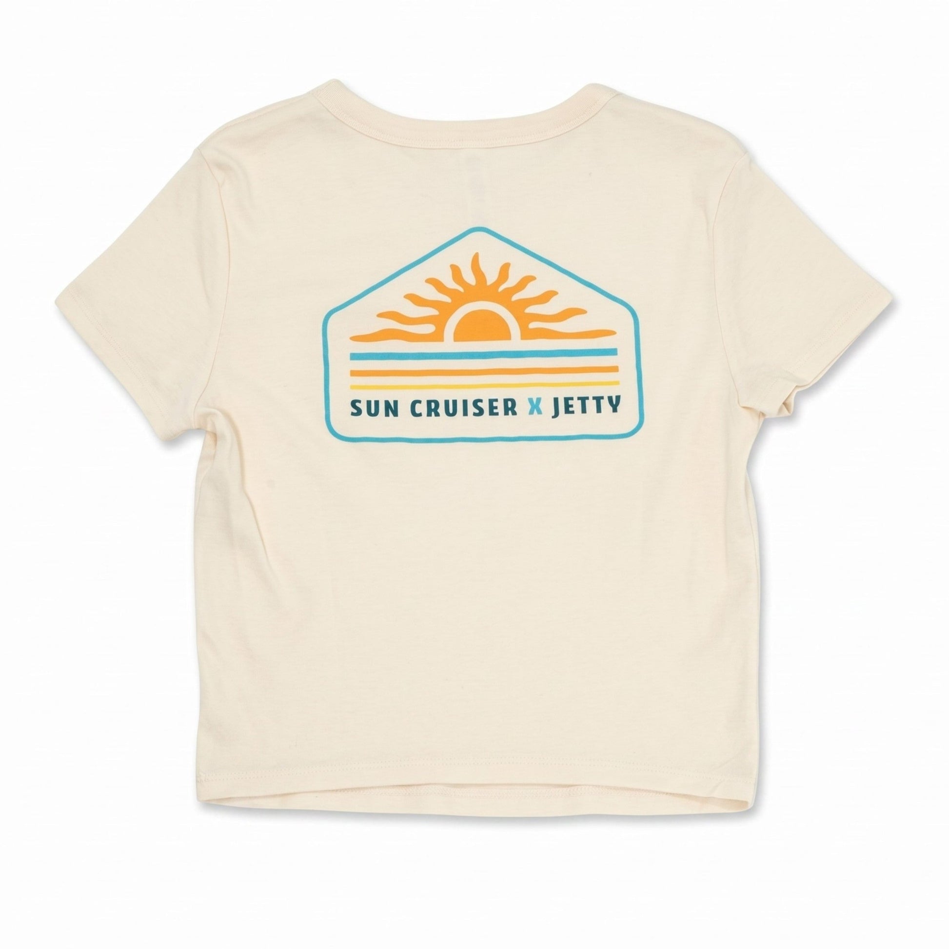 An off-white short-sleeve t-shirt with a retro-style 'Sun Cruiser x Jetty' graphic on the chest, featuring a yellow sun, orange stripes, and a teal border.