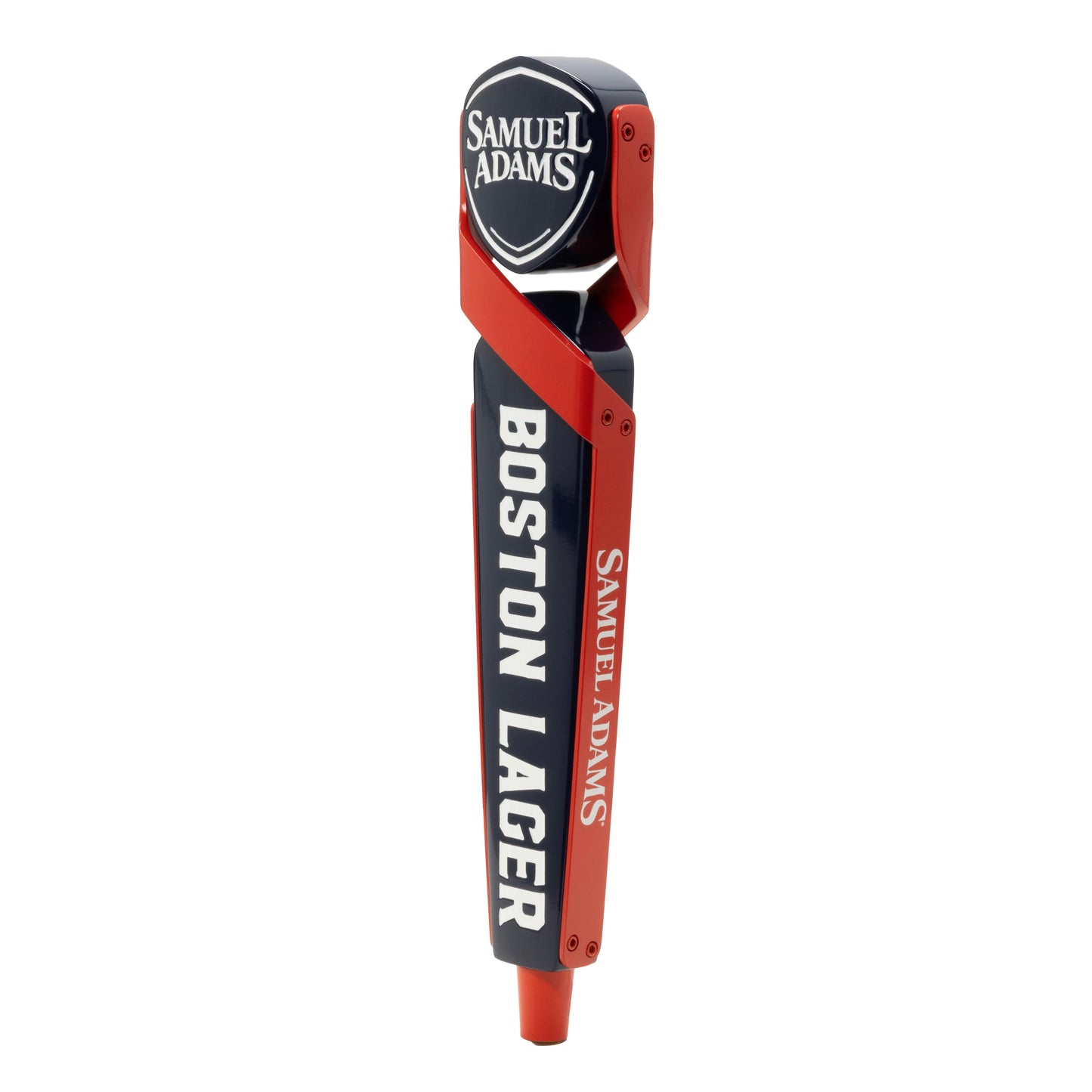 A tap handle with the Sam Adams logo written in white against a blue shield shaped piece. The shield is being held by two red shapes that cross and wrap around the edges of the tap handle.  Boston Lager is written vertically in white across the blue body of the tap handle. Sam Adams logo is written vertically in white on the red part of the tap handle. There is a red cylindrical shape at the bottom. 