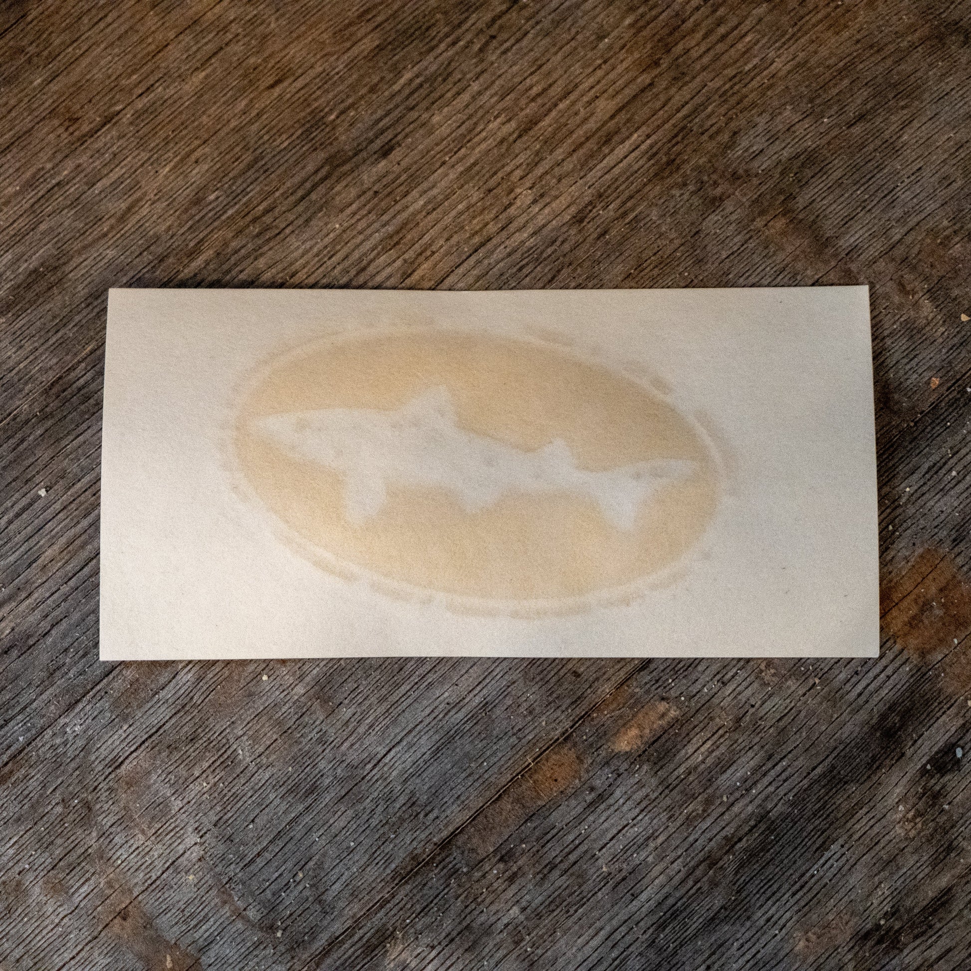 A 4-inch Logo Decal from KCB Print Resources features three stylized sharks in an oval coffee ring design, ideal for unique vinyl transfers on various surfaces.