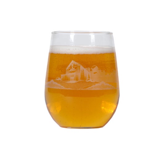 On one side of this glass is an apple and under it the writing "Angry Orchard Hard Cider". Under the writing is the beginning of a silhouette of the Angry Orchard, which continues to the next side. The other side of the glass as a full white silhouette of the Angry Orchard. 