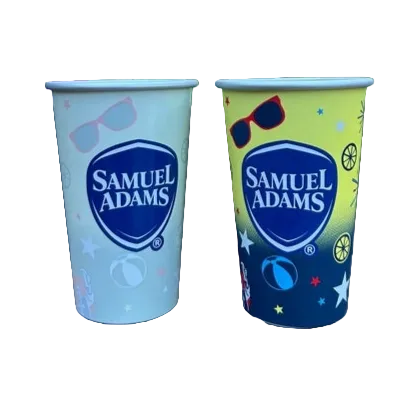 An aluminum color changing cup that goes from white with the Sam Adams shield logo to a yellow and navy gradient background with other summer design elements.