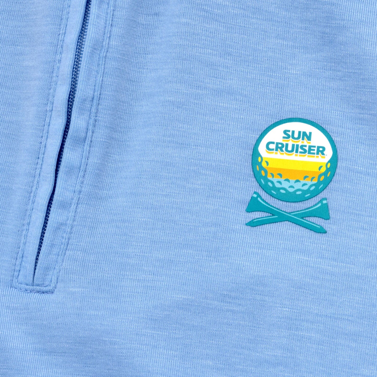 Sun cruiser golf ball and cross tee logo on  a baby blue GFORE quarter zip 
