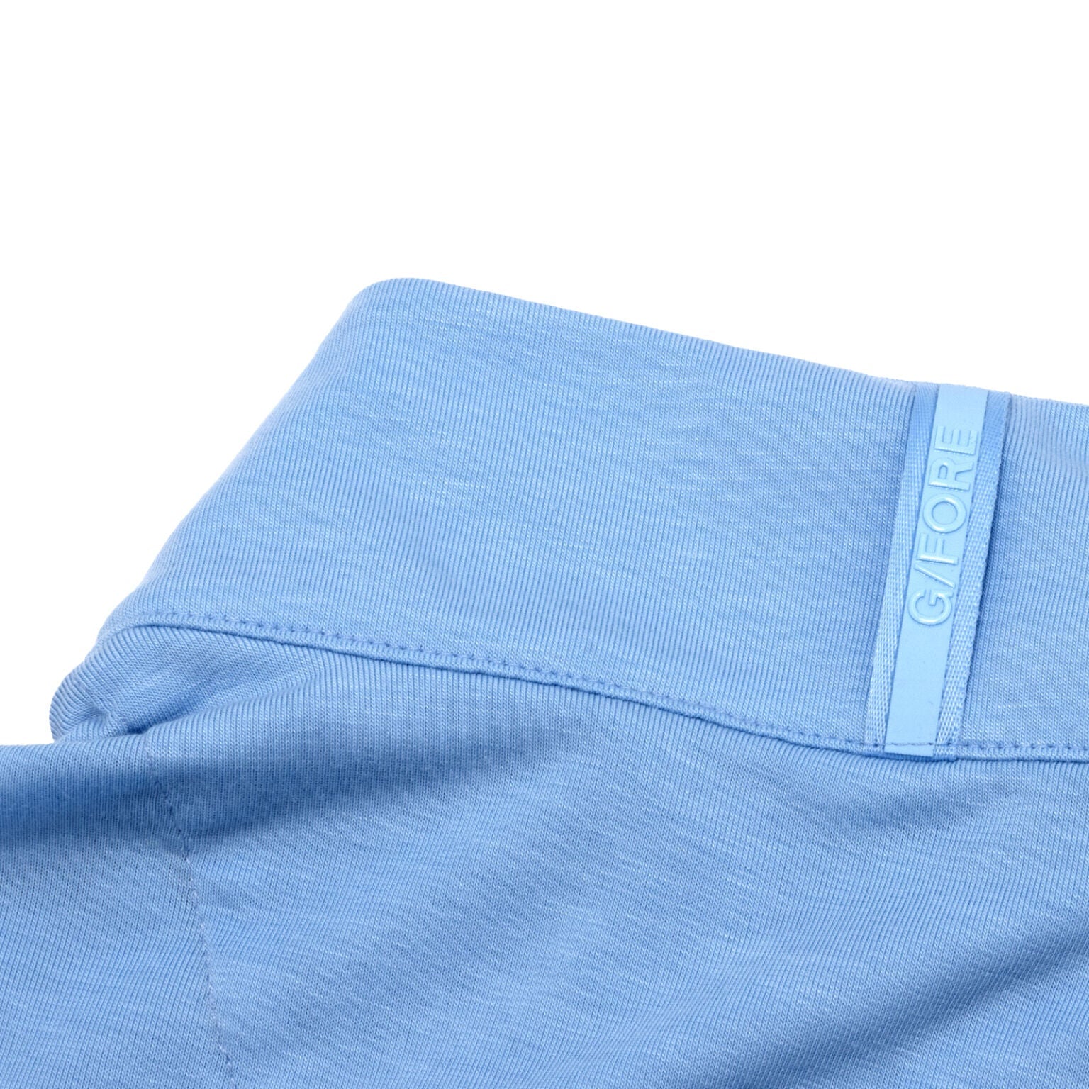 Close up of the back of the neck on Sun Cruiser x Gfore baby blue quarter zip, showing the GFORE branding