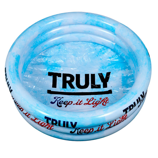 A light blue and white inflatable pool, featuring "TRULY" in bold black letters with an underline in the center, and "Keep it Light" in red cursive text below it. The pool has three inflatable rings forming the sides.