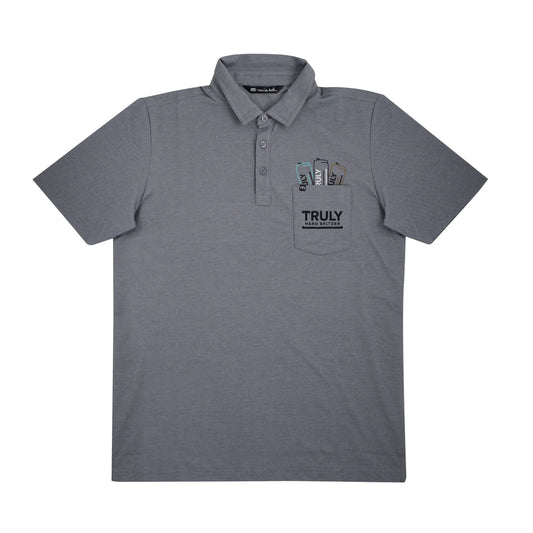 A flat lay of a grey short-sleeved polo shirt with a black collar and two buttons. The shirt has a pocket on the left chest with three partially visible slim cans embroidered inside, each labeled 'TRULY'. Below the cans, the pocket is printed with the word 'TRULY' in large black letters and 'HARD SELTZER' in smaller black letters.