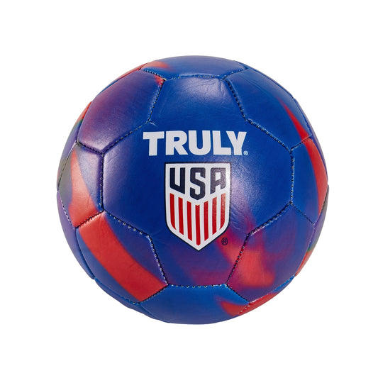 Front view of a blue and red marbled Truly USA ball with stitched panel construction, displaying white “TRULY” text and a red‑and‑blue USA shield graphic centered on the surface. The glossy finish enhances the bold, colorful design.