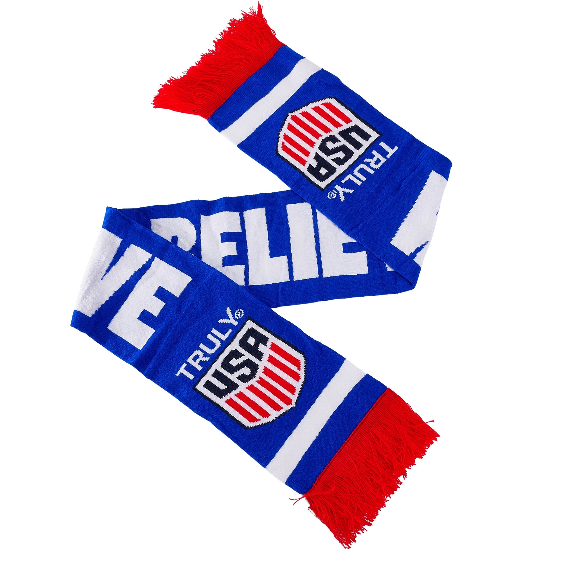 Blue, white, and red Truly USA knit scarf shown laid out in an angled shape, featuring bold white lettering, a shield‑style Truly USA logo on each end, red fringe tassels, and wide horizontal stripes; promotional branded winter scarf.