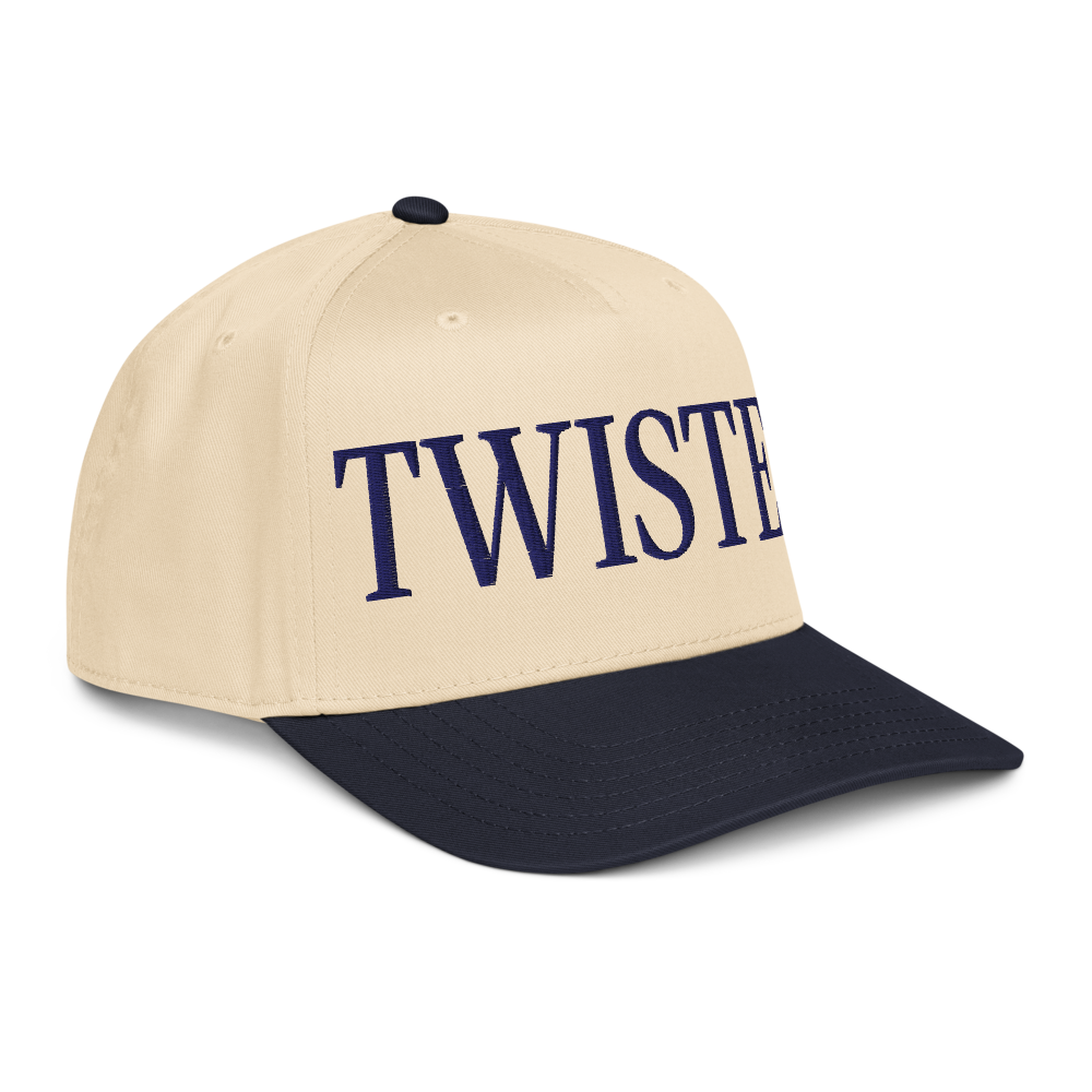 Cream and navy Twisted Tea baseball cap with curved brim, featuring large embroidered “Twisted” lettering on the front panel