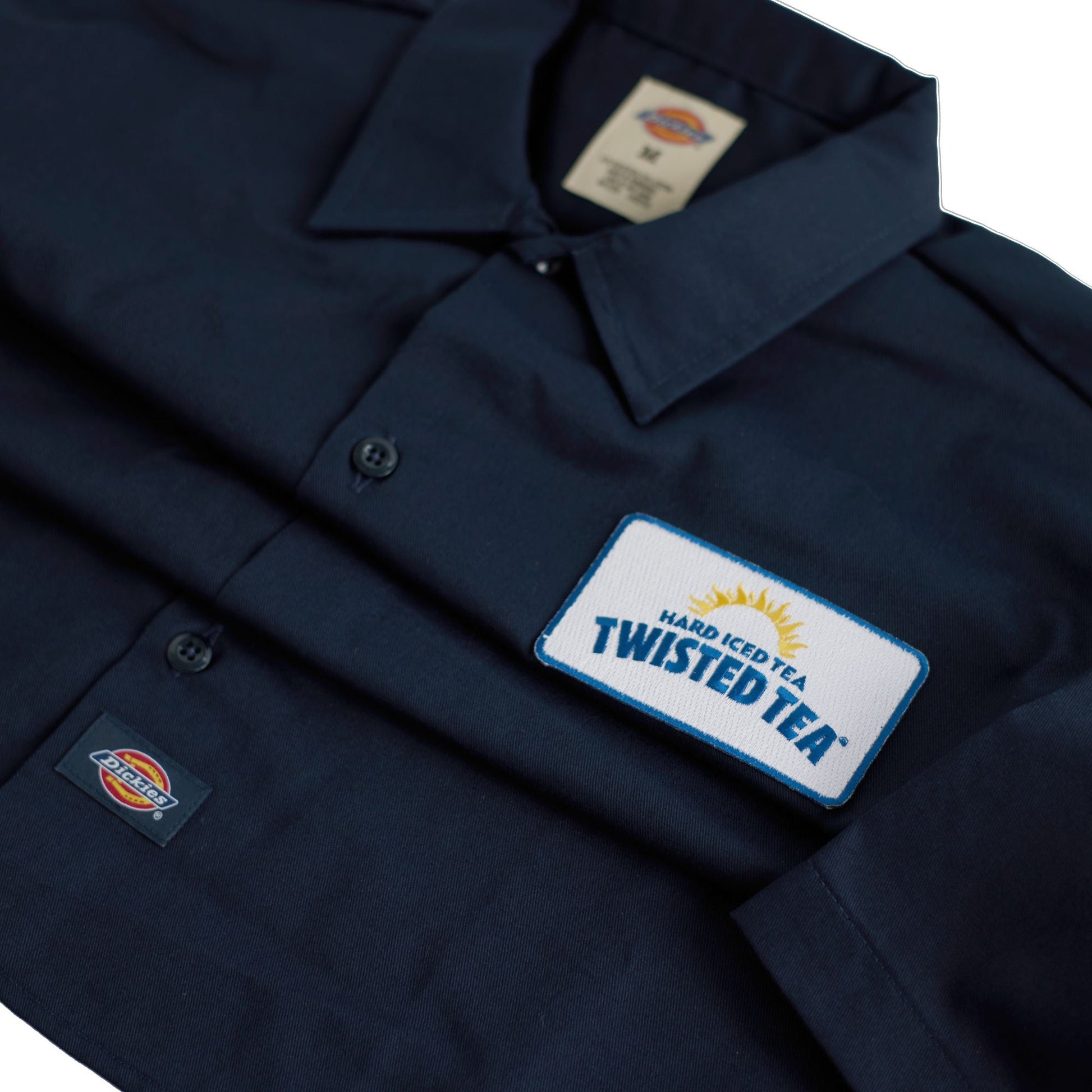 Navy shirt with Twisted Tea logo and Dickies branding on a white background