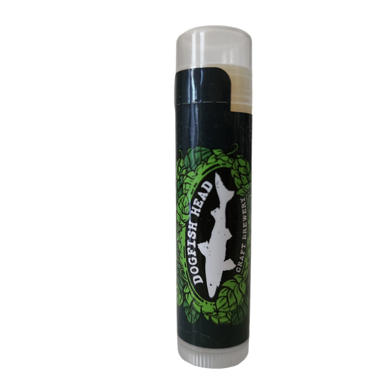 A tube of Vanilla Lip Balm by Ecolips with a black label featuring green hop illustrations and a white fish silhouette. The cap is clear and the background is white.