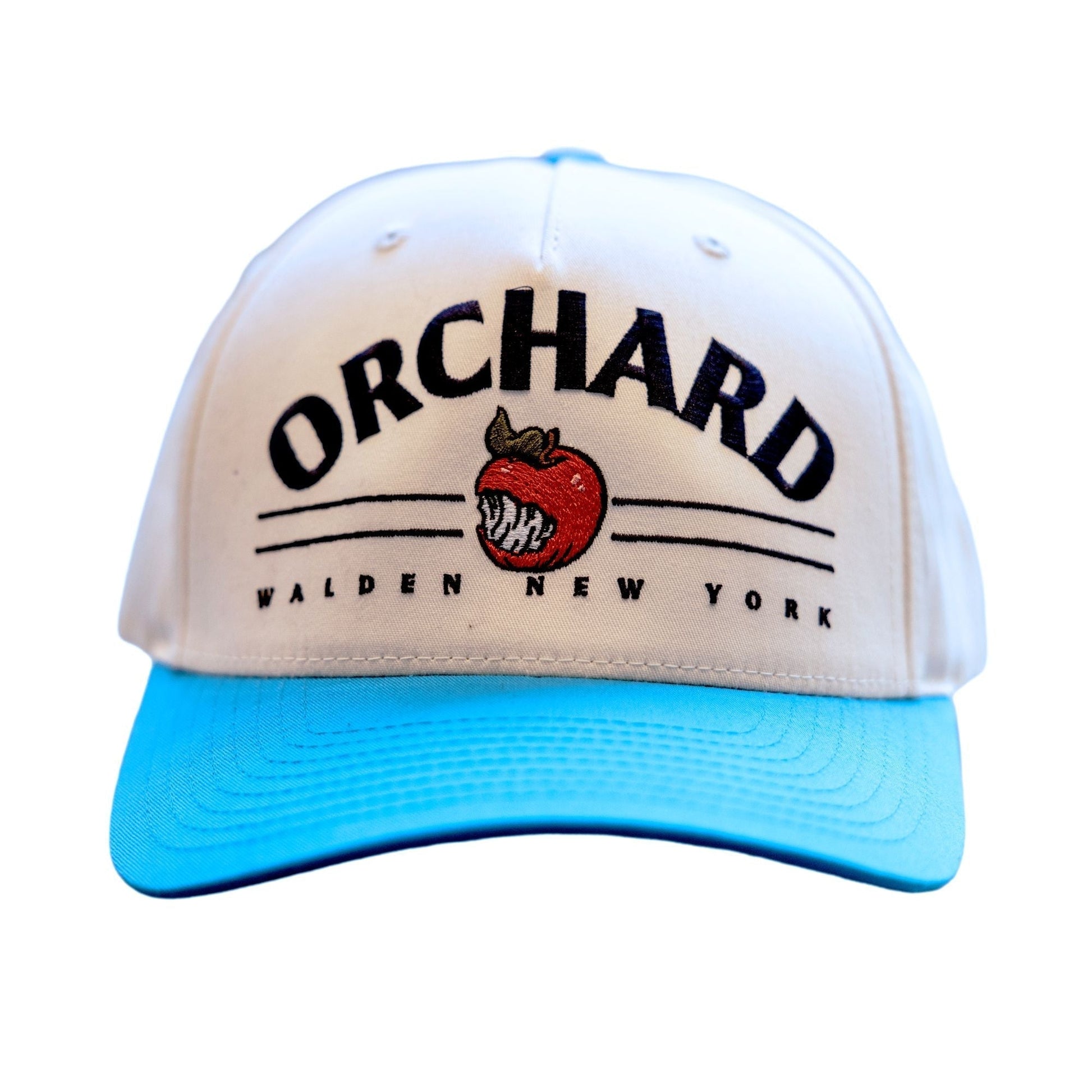 Vintage Five Panel Snapback. On the front of the hat in large arching black text reads "Orchard". Below the text are two thin, black horizontal parallel lines for design. An angry orchard apple logo breaks in the center of these lines. Underneath the lines in smaller black text reads "Walden New York" The Top button and brim are angry orchard bright blue. The 5 panels are white. 