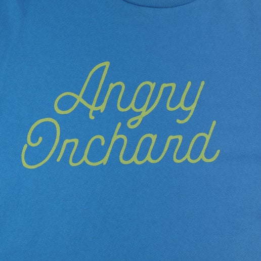 Close-up of front of blue tee displays yellow writing "Angry Orchard" in script.