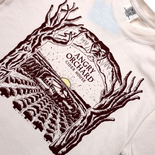 Front of tee displays a large artistic rendition silhouette of our Angry Orchard location.
