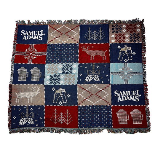 Winter Tapestry Blanket with squared, ugly sweater patterns in tan, red, light blue, and navy
