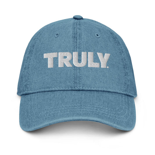 Light blue denim dad hat with a white Truly Logo front and center 