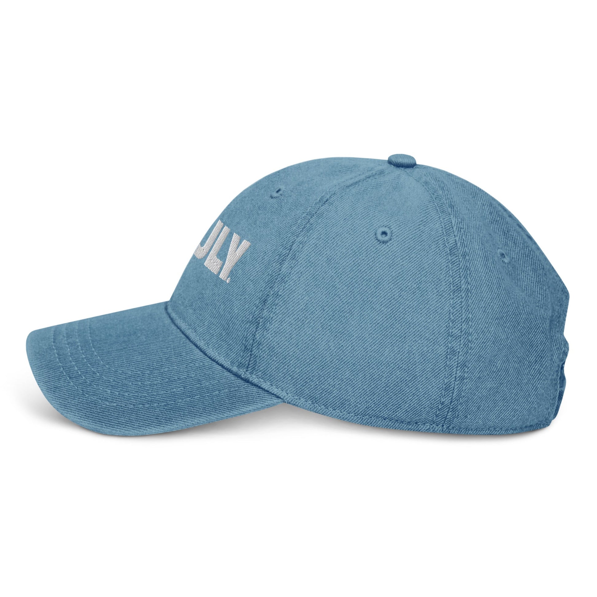 Side view of light blue denim dad hat with a white Truly Logo front and center 