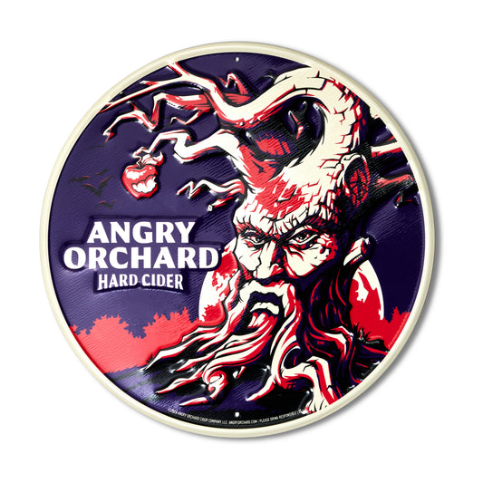 Circle metal sign with scary tree and Angry Orchard Hard Cider text. 
