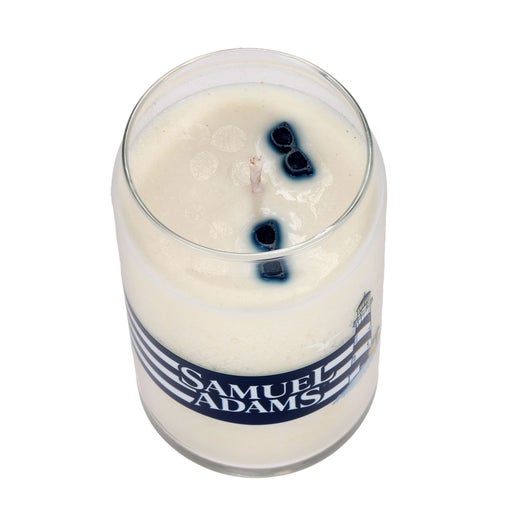 Inside view of Summer Can Glass Candle, shows tan colored wax and two blue sunglasses in the wax